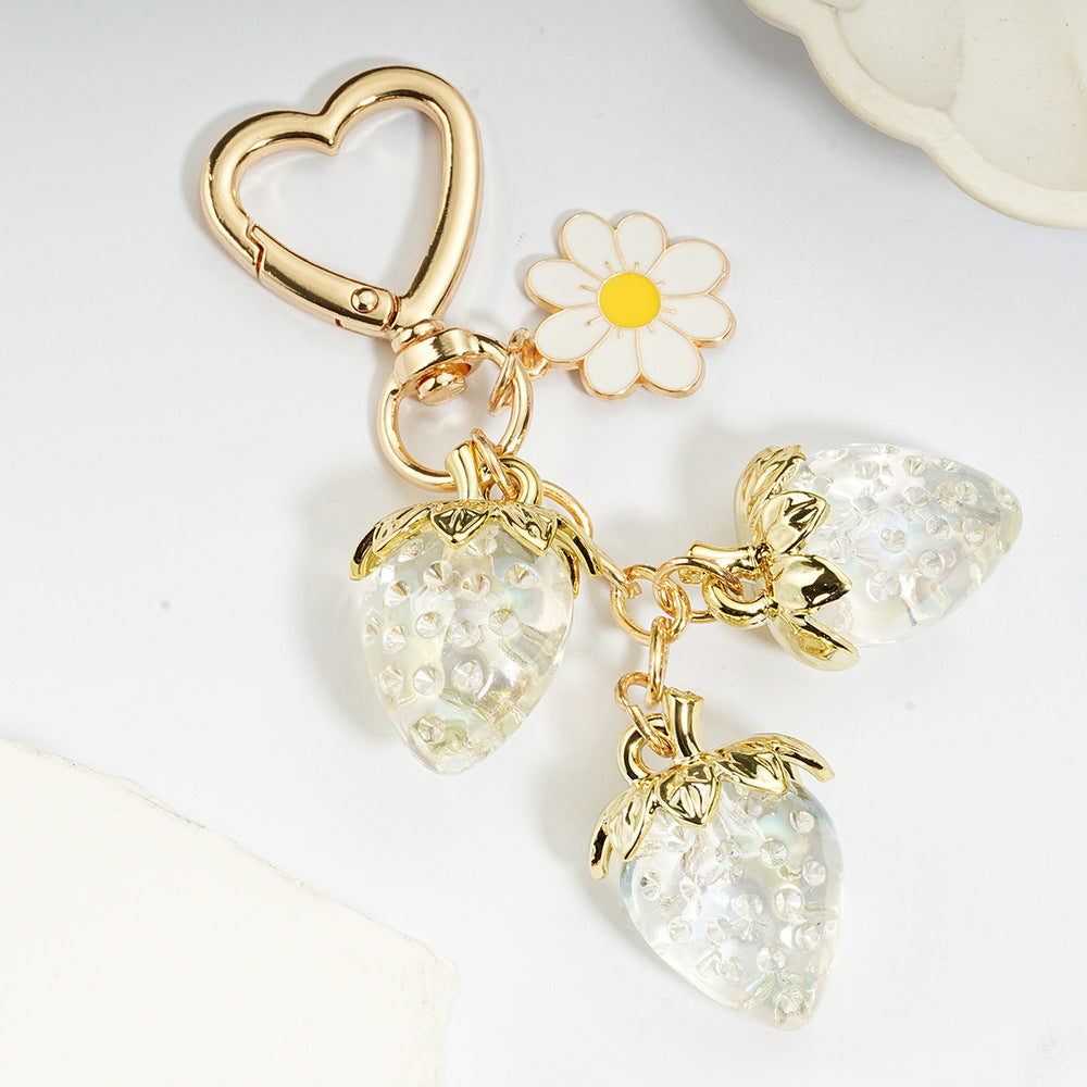 Adorable transparent strawberry keychain paired with a heart-shaped hook and daisy decorations -a sweet and stylish accessory