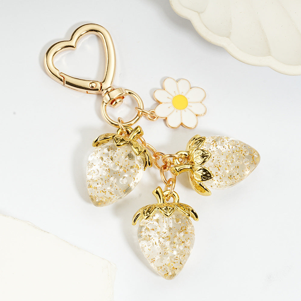 Adorable transparent strawberry keychain paired with a heart-shaped hook and daisy decorations -a sweet and stylish accessory