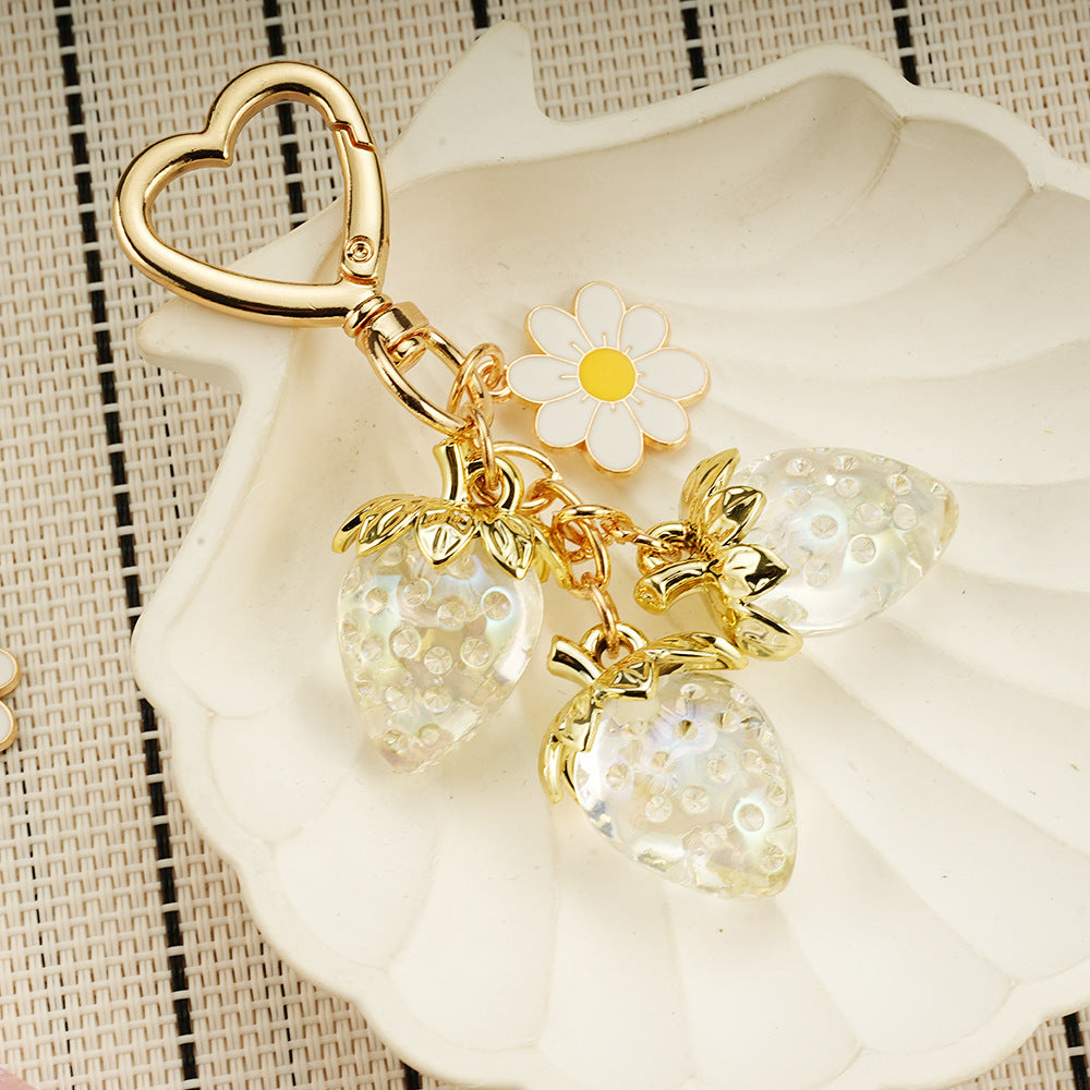 Adorable transparent strawberry keychain paired with a heart-shaped hook and daisy decorations -a sweet and stylish accessory