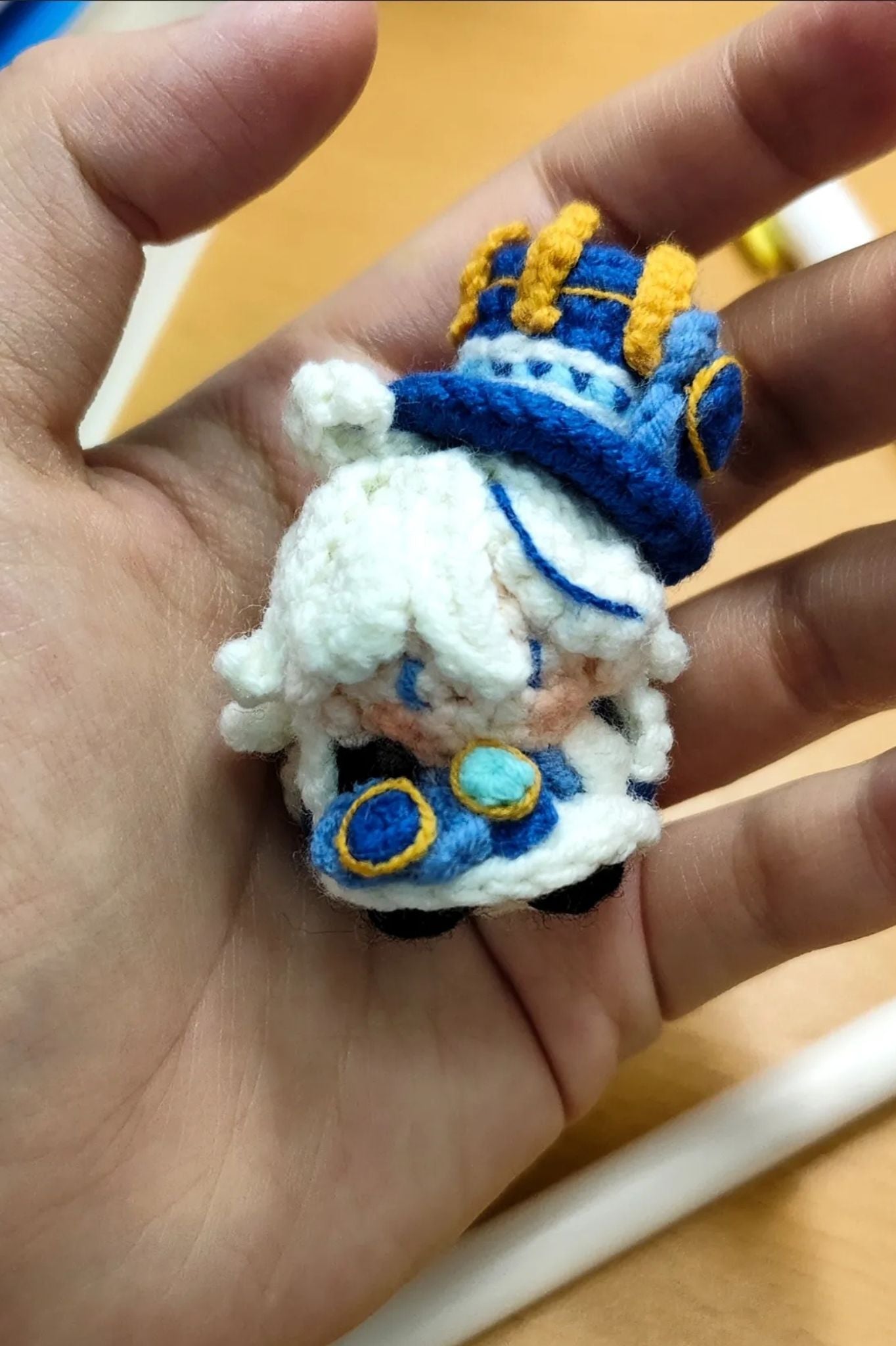 Close-up of Furina amigurumi crochet keychain — detailed handmade stitches and design