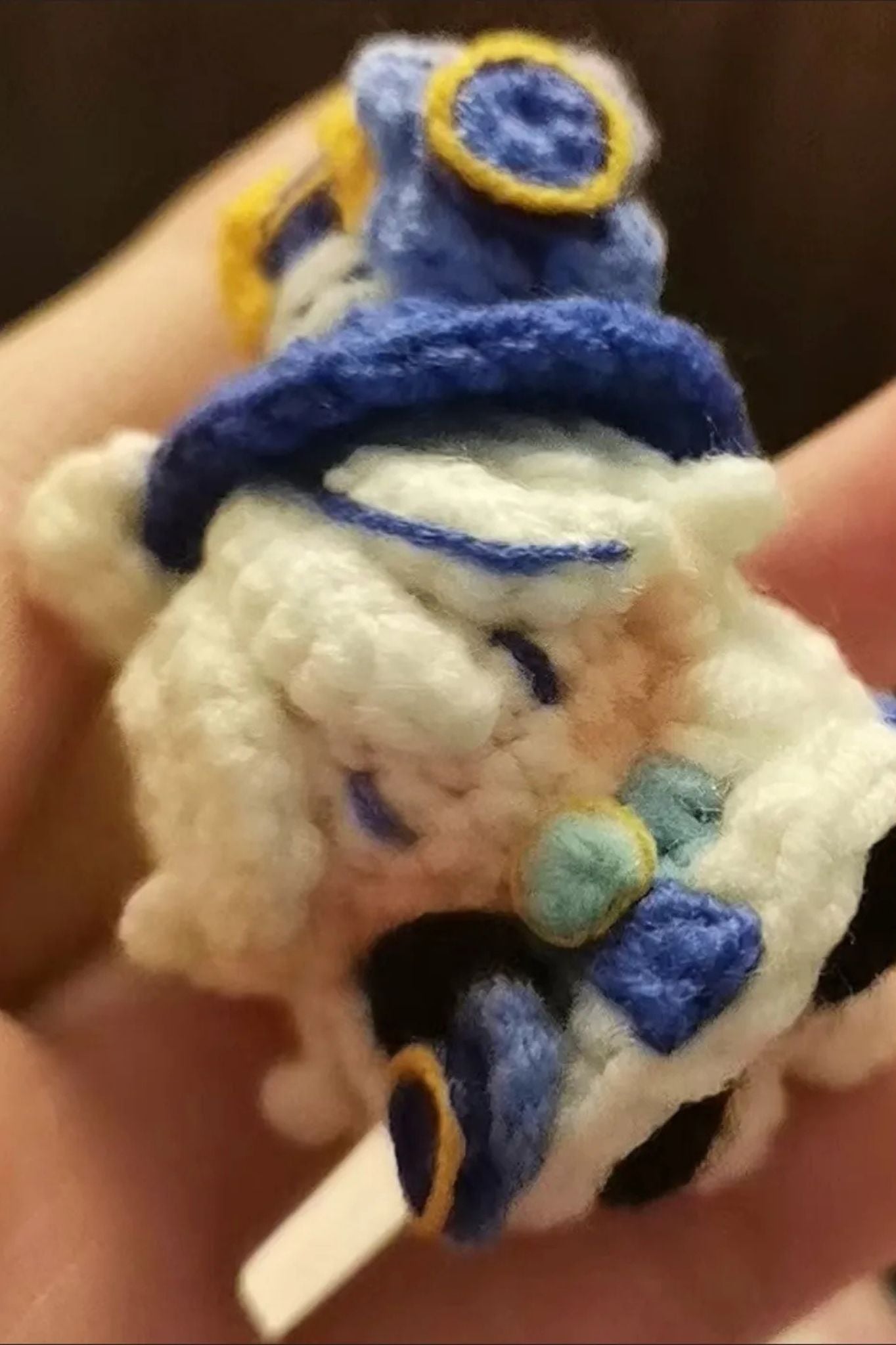 Close-up of Furina amigurumi crochet keychain — detailed handmade stitches and design