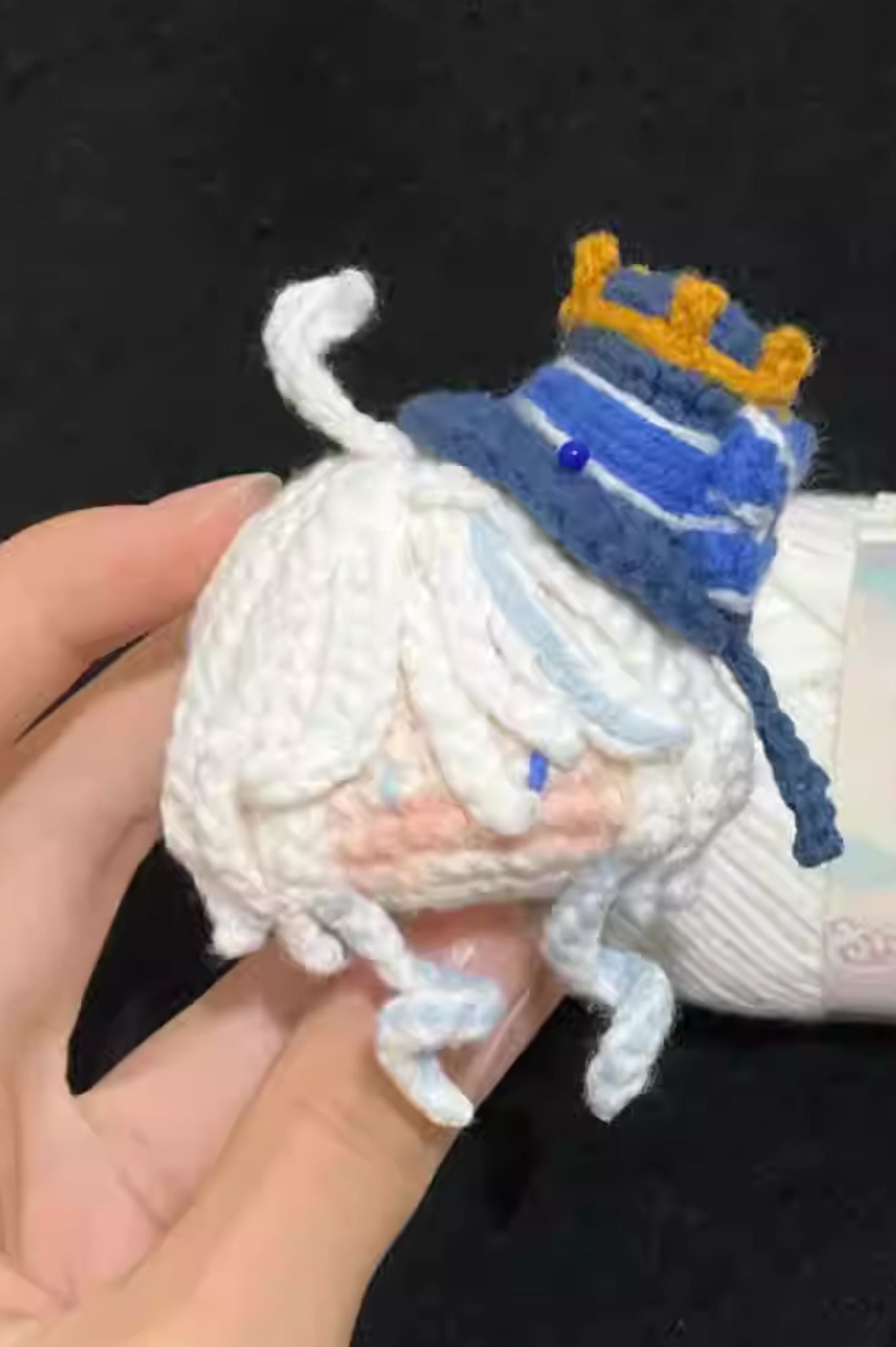 Close-up of Furina amigurumi crochet keychain — detailed handmade stitches