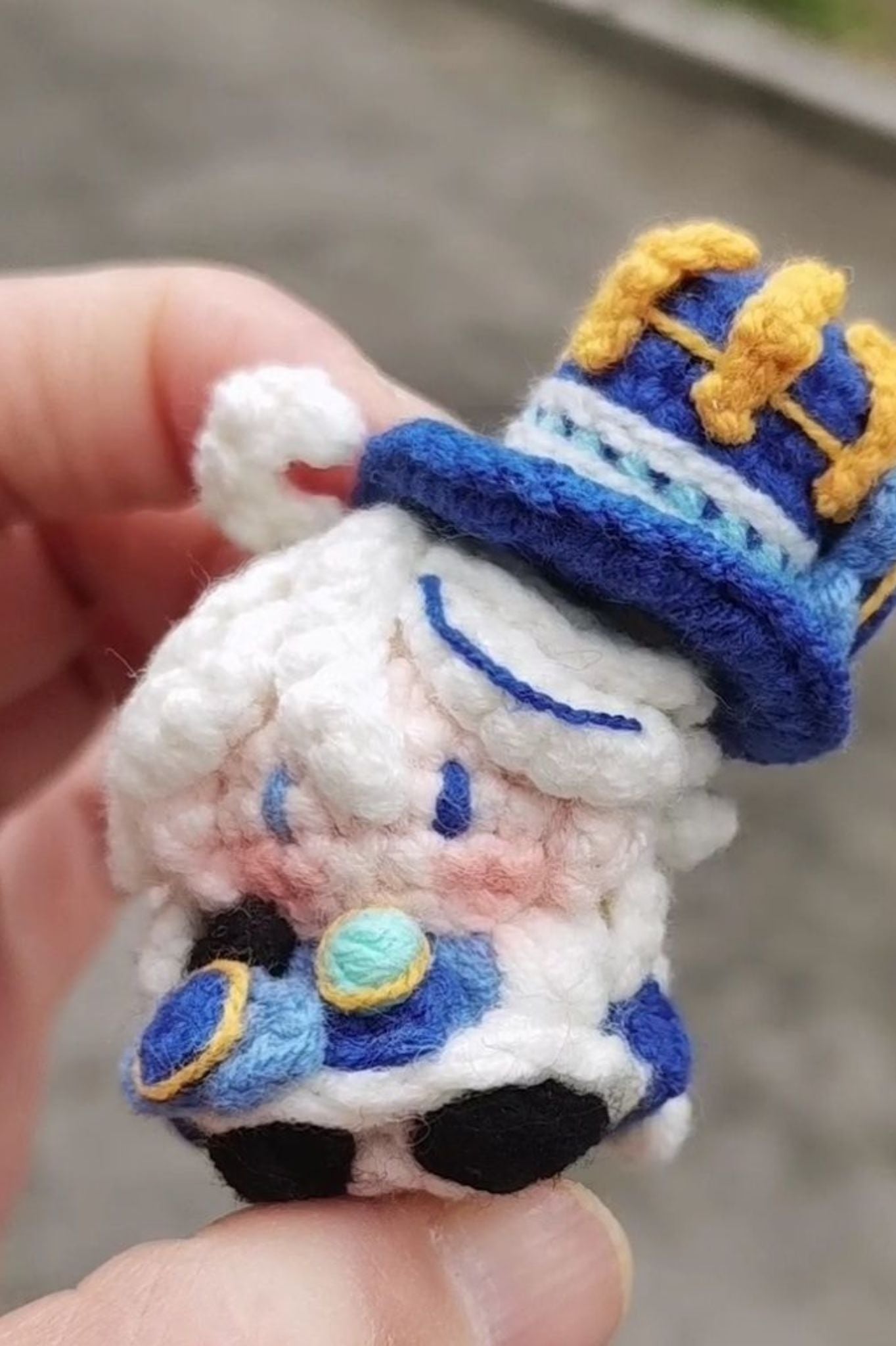 Close-up of Furina amigurumi crochet keychain — detailed handmade stitches and design