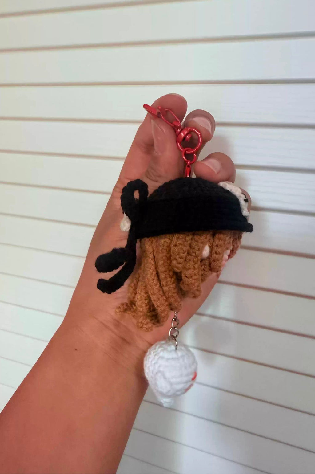 Close-up of Hu Tao amigurumi crochet keychain — detailed handmade stitches