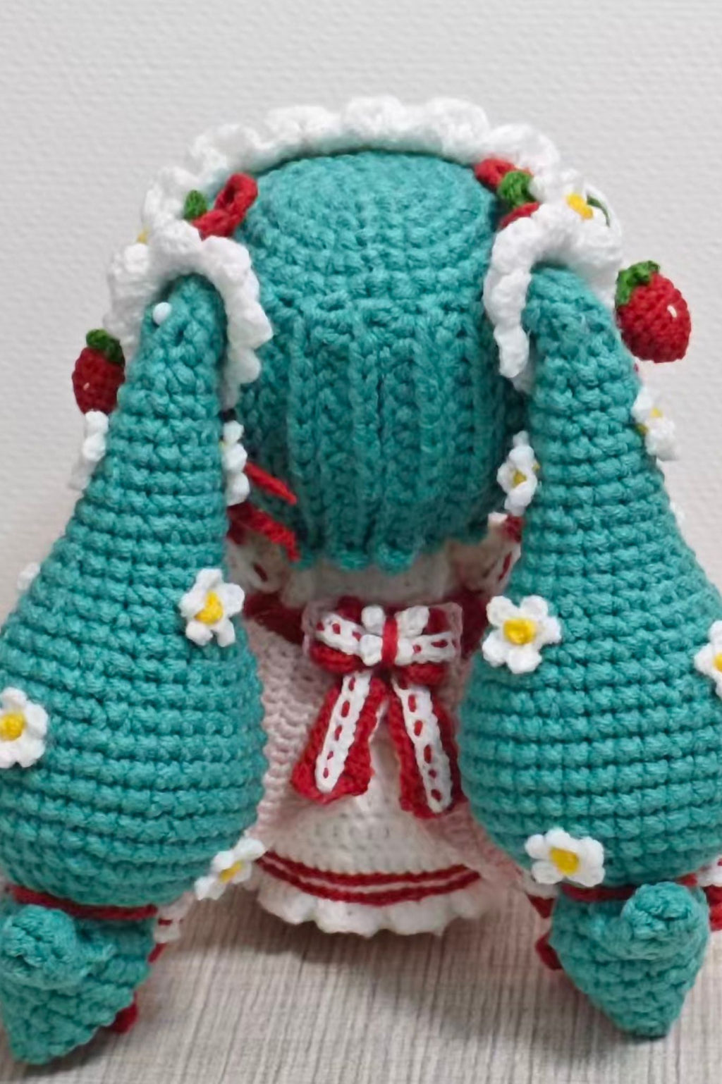 Close-up of yarn and felt pieces in Strawberry Hatsune Miku crochet DIY kit — complete materials pack