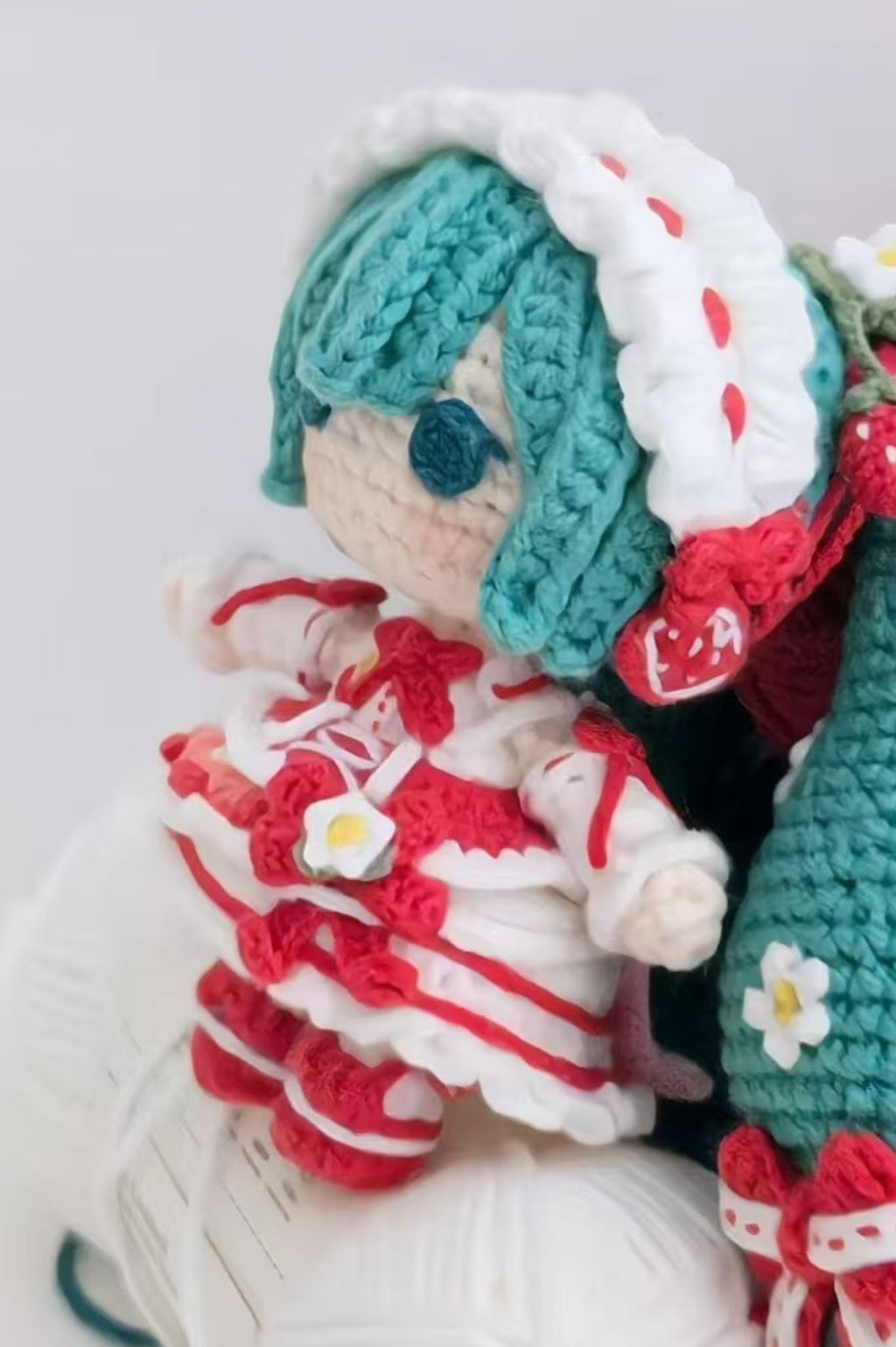Close-up of yarn and felt pieces in Strawberry Hatsune Miku crochet DIY kit — complete materials pack